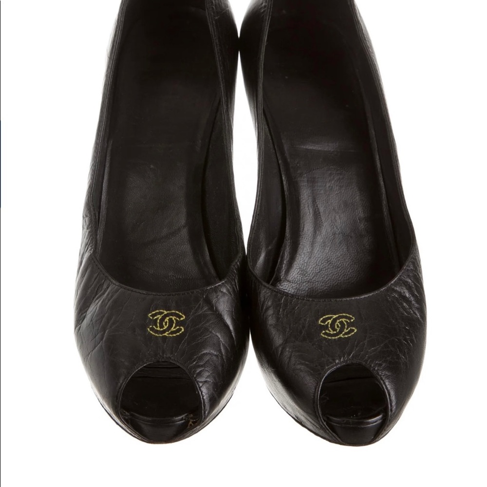 Black leather Chanel peep-toe pumps with Cc at front and covered heels.